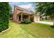 Beautiful brick home featuring lush landscaping and a welcoming front porch at 13042 Dartmore Ave, Alpharetta, GA 30005