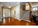 Welcoming foyer with hardwood floors, staircase and front door at 13042 Dartmore Ave, Alpharetta, GA 30005