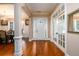 Bright foyer with hardwood floors, white trim, and a view into the adjacent dining room and French doors at 13042 Dartmore Ave, Alpharetta, GA 30005