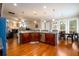 Open concept kitchen and living space with hardwood floors, a center island, and natural light at 13042 Dartmore Ave, Alpharetta, GA 30005