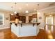 Open kitchen with island, granite countertops, stainless steel appliances, and hardwood flooring at 13042 Dartmore Ave, Alpharetta, GA 30005