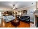 Open concept living space showcasing hardwood floors, fireplace and staircase at 13042 Dartmore Ave, Alpharetta, GA 30005