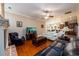Spacious living room featuring hardwood floors, fireplace, and seamless kitchen access at 13042 Dartmore Ave, Alpharetta, GA 30005