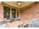 Cozy brick patio with outdoor seating, perfect for relaxing and entertaining guests at 13042 Dartmore Ave, Alpharetta, GA 30005