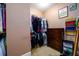 Spacious walk-in closet with ample hanging storage and shelving units at 13042 Dartmore Ave, Alpharetta, GA 30005