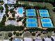 Aerial view of community tennis courts, basketball court, and pool at 158 South Village Ave, Holly Springs, GA 30115