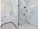 Modern bathroom with a glass shower, patterned tiling, and a marble shower surround at 158 South Village Ave, Holly Springs, GA 30115