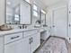 Bright bathroom with double vanity, black fixtures, and modern finishes at 158 South Village Ave, Holly Springs, GA 30115