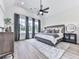 Spacious bedroom boasts vaulted ceilings, modern furniture, and large windows with natural light at 158 South Village Ave, Holly Springs, GA 30115