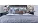 Bedroom close-up featuring a gray-toned bed and matching nightstands at 158 South Village Ave, Holly Springs, GA 30115