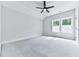 Light filled bonus room with modern ceiling fan, neutral paint, carpet, and large windows offering a scenic view at 158 South Village Ave, Holly Springs, GA 30115