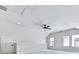 Bright bonus room with high ceilings, neutral paint, modern ceiling fan, and large windows for ample natural light at 158 South Village Ave, Holly Springs, GA 30115