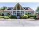 The clubhouse features a covered porch and an American flag, offering residents a place to gather at 158 South Village Ave, Holly Springs, GA 30115