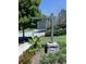 Entrance sign for The Harmony on Lake Club with a decorative banana plant at the base at 158 South Village Ave, Holly Springs, GA 30115