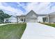 Beautiful home featuring green lawn, an inviting porch, a two-car garage providing ample space and curb appeal at 158 South Village Ave, Holly Springs, GA 30115