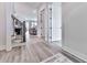 Inviting entryway with hardwood floors, iron staircase, and open sightlines into the living spaces at 158 South Village Ave, Holly Springs, GA 30115