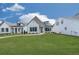 Charming single-Gathering home featuring a stone facade, manicured lawn, and black trimmed windows at 158 South Village Ave, Holly Springs, GA 30115
