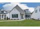 Charming single-Gathering home featuring a stone facade, manicured lawn, and black trimmed windows at 158 South Village Ave, Holly Springs, GA 30115