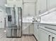 Bright and modern kitchen featuring stainless steel appliances, white cabinets, and elegant countertops for a sleek design at 158 South Village Ave, Holly Springs, GA 30115