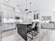 Spacious kitchen showcasing an island with seating, modern appliances, and pendant lighting, blending style and functionality at 158 South Village Ave, Holly Springs, GA 30115