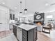 Stunning open-concept kitchen featuring a center island, modern appliances, and seamless flow to the living area at 158 South Village Ave, Holly Springs, GA 30115