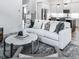 Inviting living room featuring a neutral palette, plush sofa, and stylish decor, perfect for relaxation and gatherings at 158 South Village Ave, Holly Springs, GA 30115