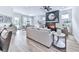 Open-concept living room featuring a fireplace, ceiling fan, and seamless flow to the dining area at 158 South Village Ave, Holly Springs, GA 30115