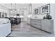 Spacious living area that leads into the kitchen, featuring modern appliances and sleek countertops at 158 South Village Ave, Holly Springs, GA 30115