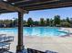 Sparkling community pool featuring lounge chairs, sun umbrellas and pergolas for rest and relaxation at 158 South Village Ave, Holly Springs, GA 30115