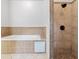 Bathroom featuring tile surround tub and a shower with tiled walls at 187 Vanira Se Ave, Atlanta, GA 30315