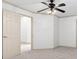 Spacious bedroom featuring neutral-toned walls, carpet flooring, and a ceiling fan with a decorative light fixture at 187 Vanira Se Ave, Atlanta, GA 30315
