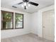 Bedroom with ceiling fan, carpet, and two windows with wood trim at 187 Vanira Se Ave, Atlanta, GA 30315
