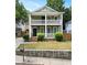 Charming two-story home with a double front porch, green siding, and well-maintained landscaping at 187 Vanira Se Ave, Atlanta, GA 30315