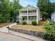 Charming two-story home with a covered front porch and balcony, complemented by a landscaped yard at 187 Vanira Se Ave, Atlanta, GA 30315