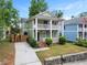 Charming two-story home with a covered front porch and second story balcony, complemented by a well-manicured lawn at 187 Vanira Se Ave, Atlanta, GA 30315