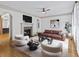 Bright living room features a fireplace, hardwood floors, neutral colors, and a ceiling fan at 187 Vanira Se Ave, Atlanta, GA 30315