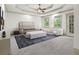 Luxurious main bedroom with tray ceiling, a sitting area, and natural light at 187 Vanira Se Ave, Atlanta, GA 30315