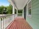 Covered wooden porch with a white railing overlooking the street at 187 Vanira Se Ave, Atlanta, GA 30315