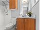 Cozy bathroom featuring a walk-in shower, wood cabinets, sink, and neutral tones at 3048 Briarcliff Ne Rd # 8, Atlanta, GA 30329