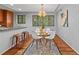Open concept dining area with a round glass table and modern chandelier at 3048 Briarcliff Ne Rd # 8, Atlanta, GA 30329