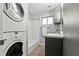 Efficient laundry area featuring stacked washer/dryer, tub, sink and storage in a compact space at 3048 Briarcliff Ne Rd # 8, Atlanta, GA 30329