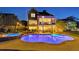 Backyard with pool, hot tub, and outdoor dining area, illuminated with exterior lighting at 3185 Casteel Ne Rd, Marietta, GA 30062