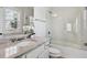 Bathroom with granite counters, white vanity, a shower over tub, and framed mirror at 3185 Casteel Ne Rd, Marietta, GA 30062