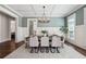 Stylish dining room featuring wainscoting, a modern chandelier, and a view into the adjacent living space at 3185 Casteel Ne Rd, Marietta, GA 30062