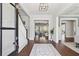 Inviting foyer with dark wood floors, white trim, and an elegant staircase leading to the upper level at 3185 Casteel Ne Rd, Marietta, GA 30062