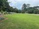 Spacious front yard with lush green grass and well-maintained landscaping, complemented by a charming white fence at 3185 Casteel Ne Rd, Marietta, GA 30062