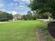 Expansive front yard featuring lush greenery, a classic white fence, and mature trees surrounding a beautiful home at 3185 Casteel Ne Rd, Marietta, GA 30062