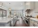 Modern kitchen with white cabinets, stainless appliances, and an island with seating, flowing into the dining area at 3185 Casteel Ne Rd, Marietta, GA 30062