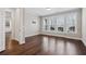 Spacious living room features hardwood floors, three large windows, and a doorway to another room at 3185 Casteel Ne Rd, Marietta, GA 30062