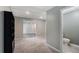 Carpeted basement area with a bathroom, and access to a finished bonus room with laminate flooring at 4146 Mcever Park Dr, Acworth, GA 30101